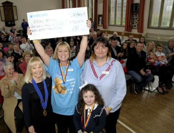 Michelle Lonican of Brian House with a cheque for the Â£13,250 proceeds of the Lytham St Annes Lions swimarathon