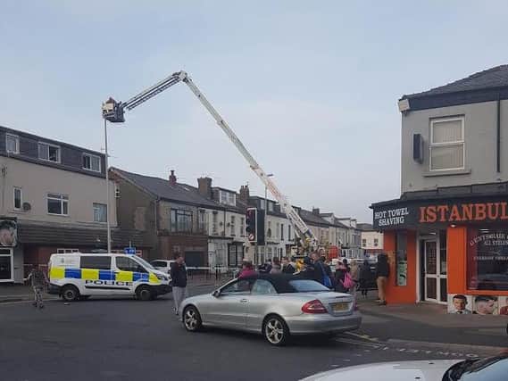 Police at the scene of a rooftop stand-off in Caunce Street