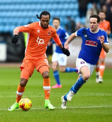 Blackpool's Nathan Delfouneso vies for possession with Carlisle United's Luke Joyce