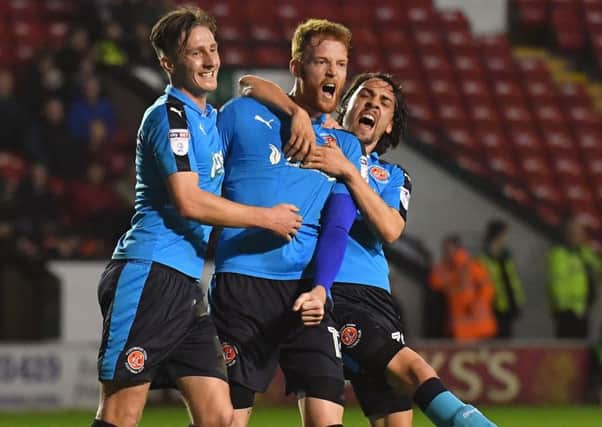 Fleetwood Town's Cian Bolger is congratulated by Davies and Schwabl after scoring at Walsall