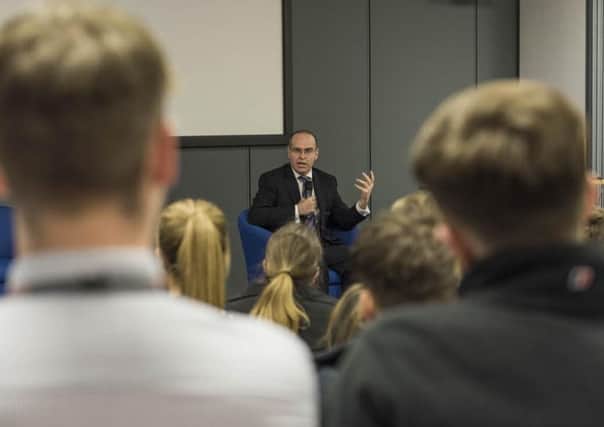 Dave Holmes, Manufacturing Director at BAE Systems Military Air & Information, speaks with apprentices at a Meet the Director session held by the company for National Apprenticeship Week.
