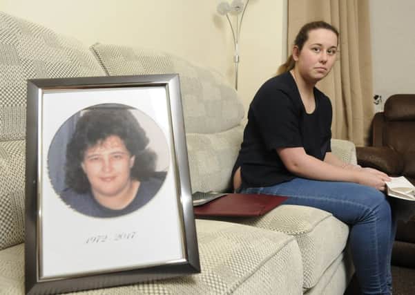 18-year-old student Jade Park with a picture of her mother, Kym Jones