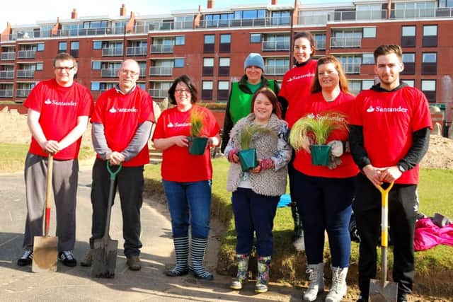 St Annes In Bloom chairman Fiona Boismaison (back, wearing green) with Santander bank staff working on the refurbishment of the Peace Garden on St Annes seafront