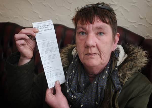 Georgina Hewlitt had been in Blackpool on holiday for less than ten minutes when she was slapped with an Â£80 fine for dropping her cigarette end in the street.
Georgina with her fine notice.  PIC BY ROB LOCK
22-3-2017
