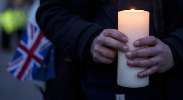 Members of the public during the candlelight vigil in Trafalgar Square, London to remember those who lost their lives in the Westminster terrorist attack. Lauren Hurley/PA Wire