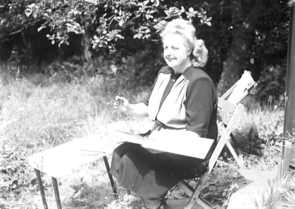 Tessie O'Shea painting in the garden "Rose Cottage" her home in Poulton, in 1945