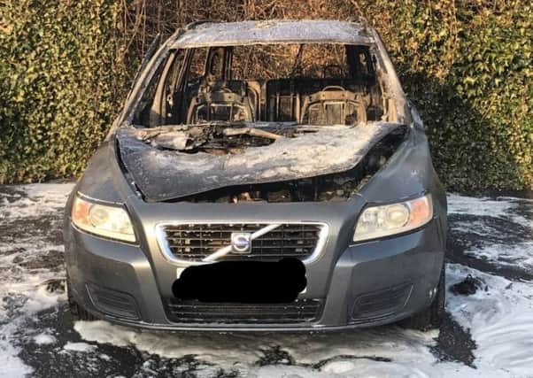 The Volvo estate car was parked at the back of a garage forecourt, the fire service said