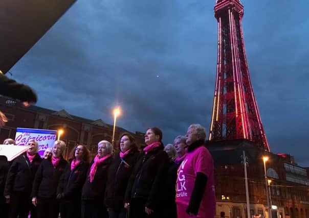 The Capricorn Singers launch the Cancer Research Race For Life 2017 singing in front of the Tower, all lit up pink