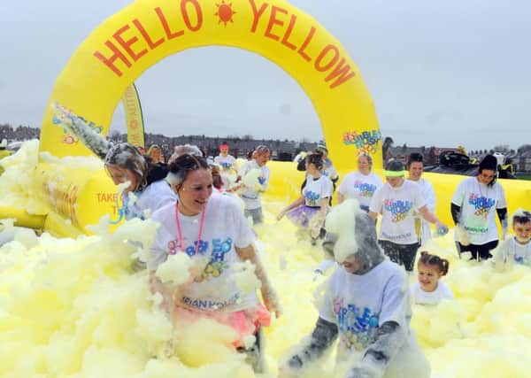 Thousands take part in the Blackpool Bubble Rush, completing a 5k course while covered in foam and bubbles, raising funds for Brian House Children's Hospice