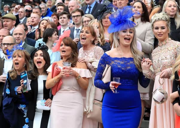 Female racegoers react in the crowd during day one of the Randox Health Grand National Festival at Aintree Racecourse. PRESS ASSOCIATION Photo. Picture date: Thursday April 6, 2017. See PA story RACING Aintree. Photo credit should read: Peter Byrne/PA Wire