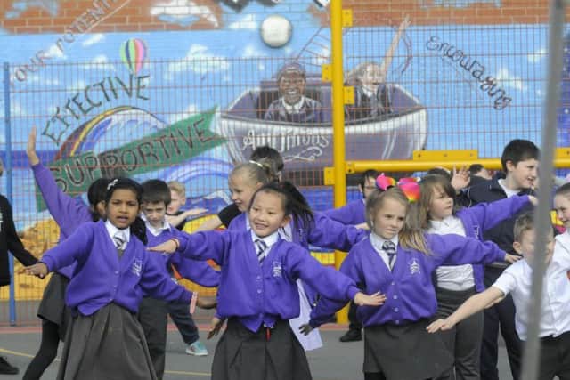 Youngsters from Thames Primary Academy perform a dance to celebrate new artwork on the wall of their school by artist Rachel 'Jeffrie' Jackson