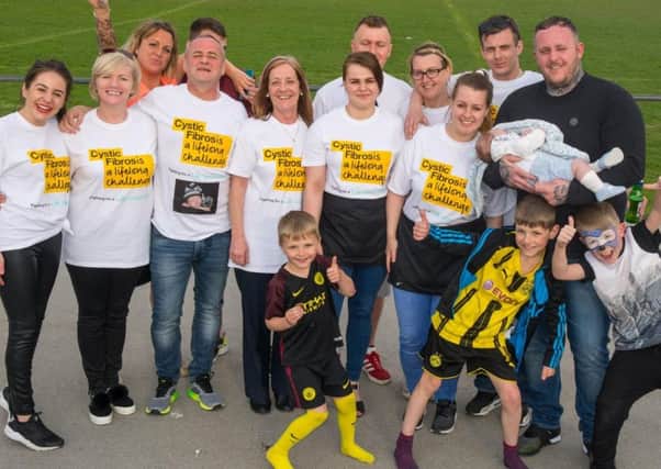 Keiha Longson and Wayne Mitchinson, right, with their baby son Wynter and supporters during a fund-raiser for the Cystic Fibrosis Trust, at Fleetwood Rugby Club.