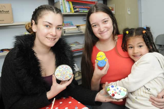 Clifton community volunteers take part in stone decorating at the library with two volunteers winning rewards for their services.  Pictured are Amanda Garwood and Lauren Garwood with 4-year-old Willow Garwood.