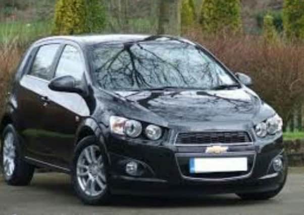 A black Chevrolet Aveo, similar to the one stolen