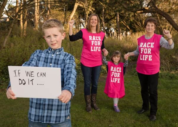 Young cancer survivor Joe Ball pulls on his trainers alongside mum Caroline Ball, younger sister Emily Ball and grandmother Ann Gaughan as they call on women to play their part in beating cancer by signing up for Cancer Research UKs Race for Life events in Blackpool
Pic: Julie Lomax Photography