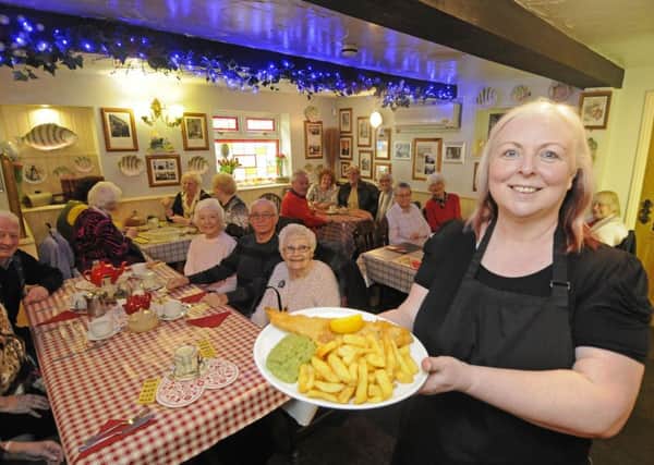 Liz Tyler from the Cottage Chippy feeds members of the Friends of Stanley Park following a refurbishment of the restaurant