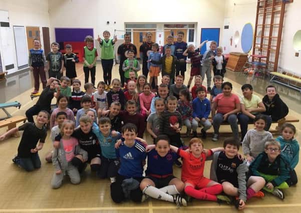 Blackpool FC Community Trust's Easter Sports Camps and Inclusion Camp last week.
Blackpool FC players Brad Potts and Dean Lyness with children