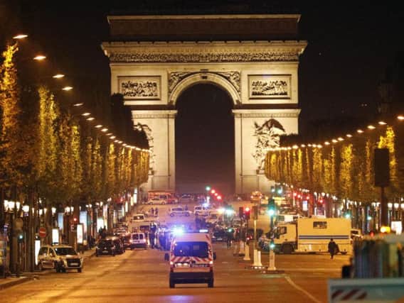Police take positions on the Champs Elysees after the shooting (AP)