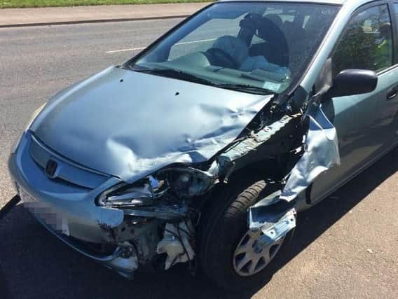 A silver Honda was left after smashing into a parked car.