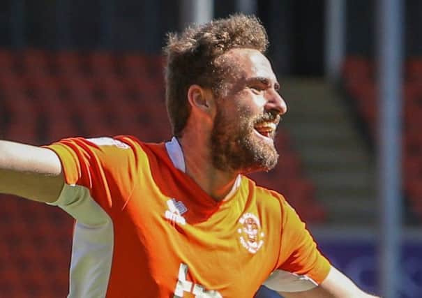 Clark Robertson celebrates his first goal of the season during Saturdays win against Cheltenham Town
