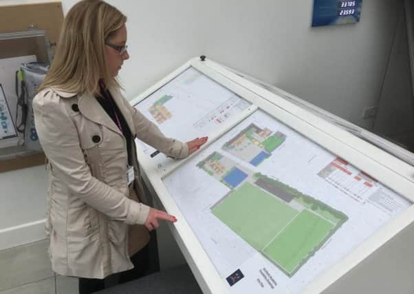 Charlotte Vickers, admin officer at the Solaris Centre views plans for the Armfield Academy