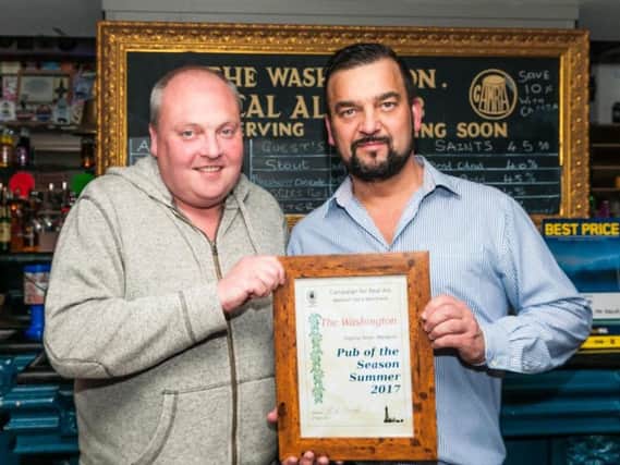 Blackpool, Fylde and Wyre CAMRA branch chairman Paul Smith, left, presents the pub of the season award to Washington landlord Stuart Culley