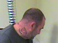 Pete Dunville has a distinctive tribal-style tattoo on the left side of his face
Pic: Lancs Police