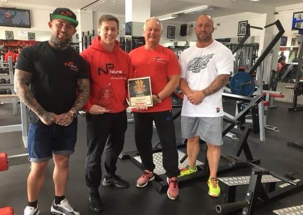 Gym staff with their prize plaque