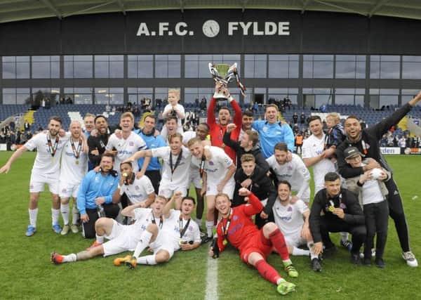 Champions AFC Fylde celebrate with the trophy