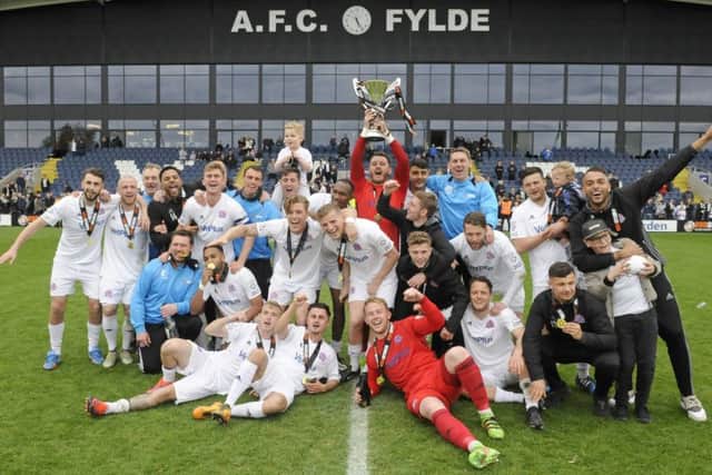 Champions AFC Fylde celebrate with the trophy