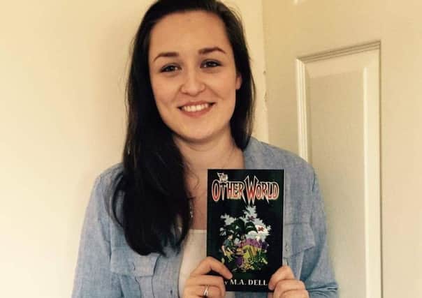 Megan Dell with  a copy of her book