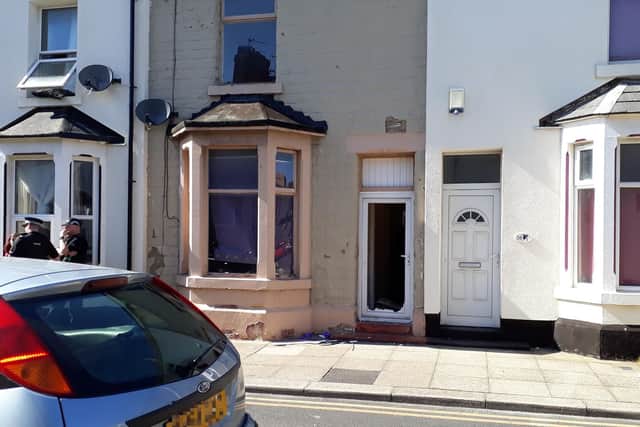 The front door of a house was left smashed in following the stand-off