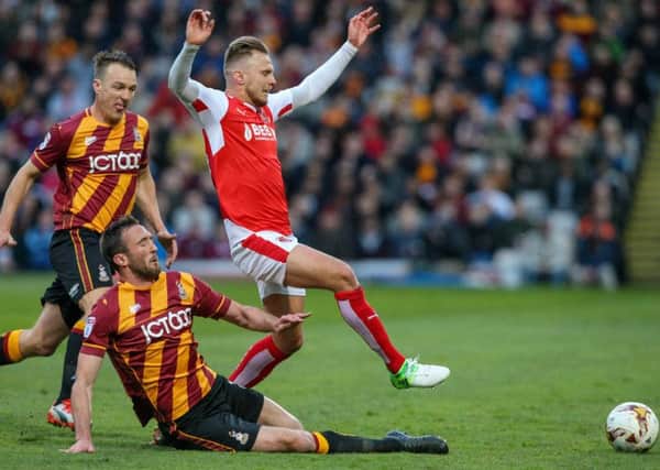 Bradford goalscorer Rory McArdle tackles David Ball