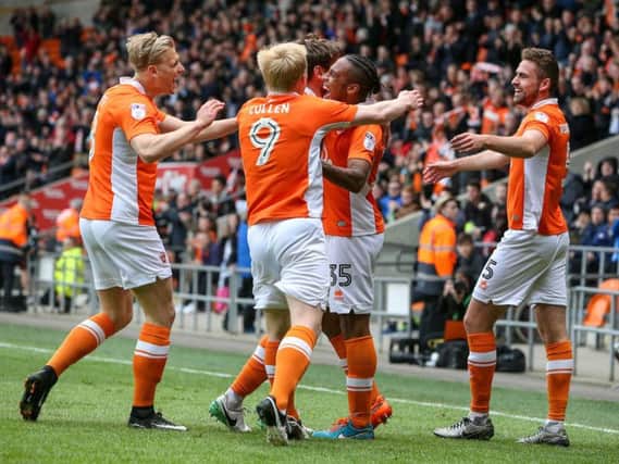 The Blackpool players celebrate Neil Danns' opener