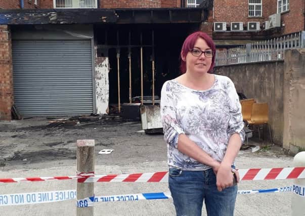 Manager Rachel Brown shows the damage to the Cancer Research UK store in Victoria Road West, Cleveleys