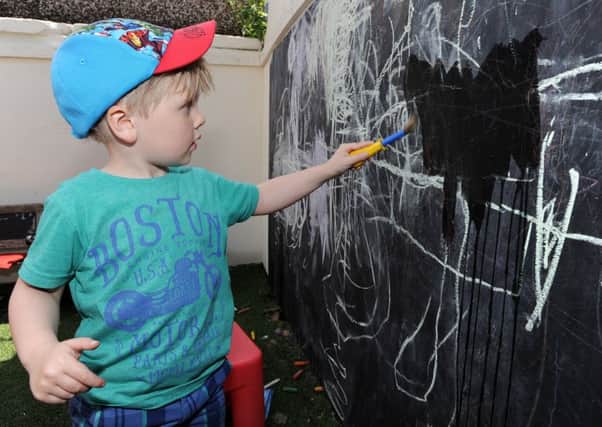 Charlie Daniels cleans the blackboard as Summerfield Nursery in St Annes marked World Outdoor Classroom Day with activities centred around its newly-revamped outdoor classroom