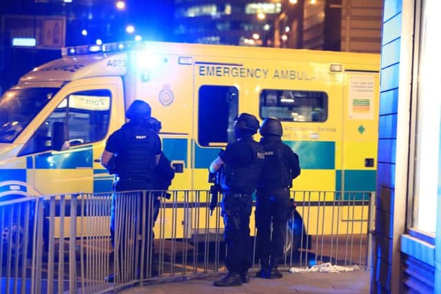 Armed police next to an ambulance after a suspected terrorist attack at the Manchester Arena at the end of a concert by US star Ariana Grande left 19 dead (Pic: Peter Byrne/PA Wire)
