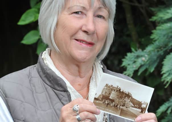 Lynn Harter with the long lost postcard
