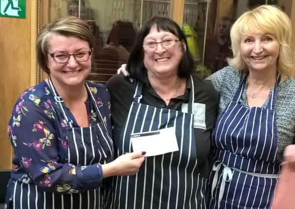 Hilary Craig (centre) manager of the Mustard Seed Group, Fleetwood, receives a cheque from the town's Rolling Scones WI members Angela Rawcliffe (left) andf Tracey Beeston.