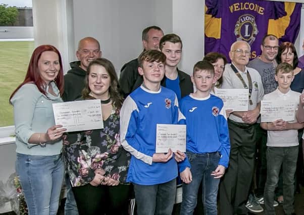 The teams from this year's Fleetwood and Cleveleys Lions' Swimarathon with cheques for the recipients. Photo: Adrian Patrick