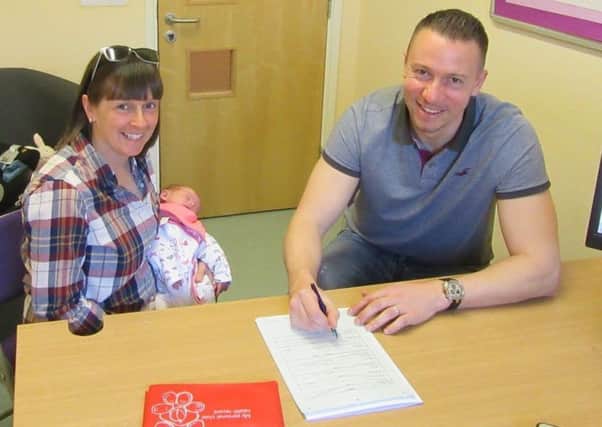 Hayley and Richard Waddington registering their child Georgie's birth at one of Blackpool's children's centres