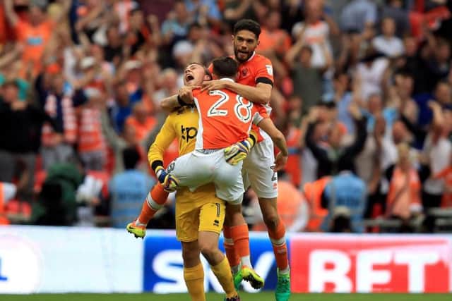 Blackpool goalkeeper Sam Slocombe (left) celebrates with Blackpool's Jack Payne and Kelvin Mellor (right)