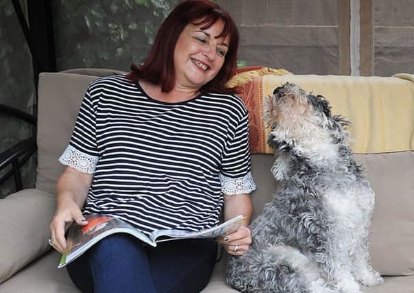 Elizabeth Ruffley, of Ripon Road in Ansdell, who has suffered from ME since 2011.
Elizabeth in the garden with her beloved Schnauzer Curly.  PIC BY ROB LOCK
28-5-2017