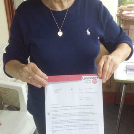 Kath Jebson with the bill for care for mum Irene Kay