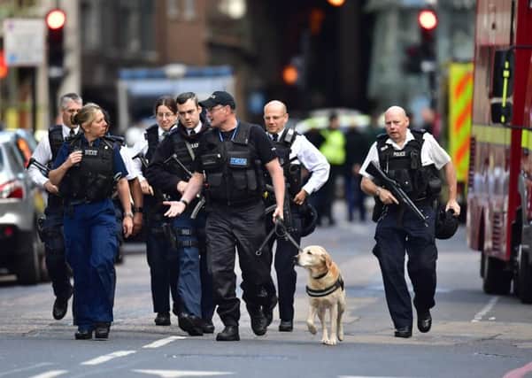 Armed police on St Thomas Street, London, near the scene of last night's terrorist incident at Borough Market. PRESS ASSOCIATION Photo. Picture date: Sunday June 4, 2017. See PA story POLICE Bridge. Photo credit should read: Dominic Lipinski/PA Wire