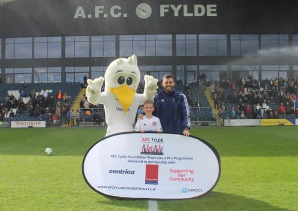 Luke Young, aged eight, with a representative from AFC Fylde Community Foundation, Nathan Davies