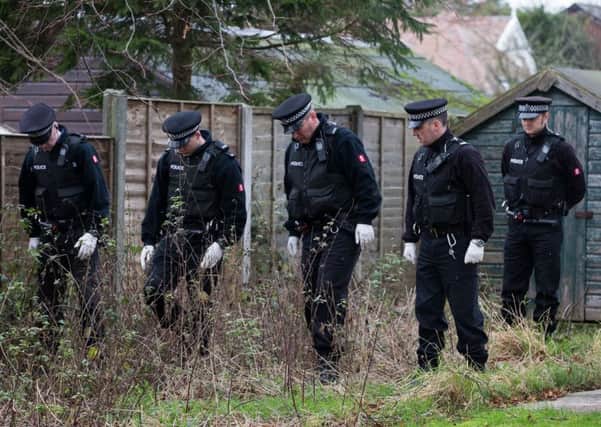 Police search the grounds of the vicarage in 2014