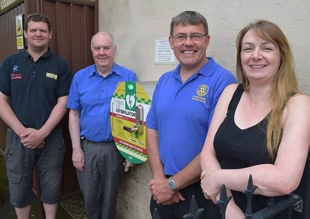 Fleetwood Rotarians Kris Butler,  Maurice Dowsing (president) and Richard Newson (also chairman of ther Fielden Trust) attend the official presentation of a new public defibrillator, with cafe/bokshop boss Alli Thompson.