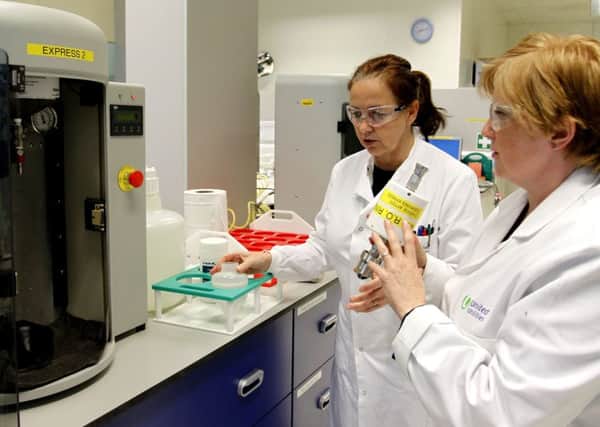 Technician Janette Williams (right) tests a sample of water at a United Utilities laboratory in Warrington, to check for traces of the microscopic bug cryptosporidium