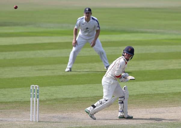 Alex Davies hits a boundary on his way to a century